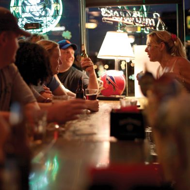 Patrons laugh and socialize at an Irish tavern during Saint Patrick's Day in Buffalo.