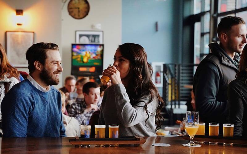 People enjoying beer flights at a bar