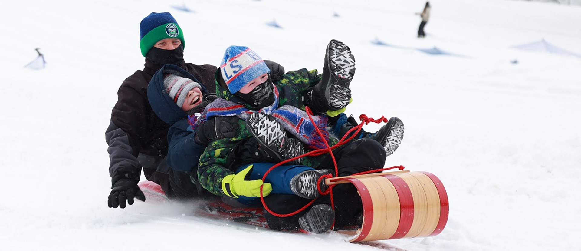 Nick Bado, left, of Tonawanda, and his son Everett, 10, center, and his friend Liam O&rsquo;Connor have fun tobogganing at Chestnut Ridge Park in Orchard Park, Saturday, January 20, 2024. Photo by Sharon Cantillon.