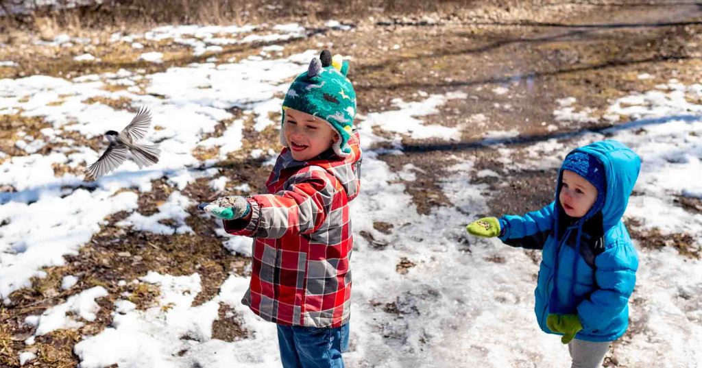 Children playing in the snow at Tifft Nature Preserve