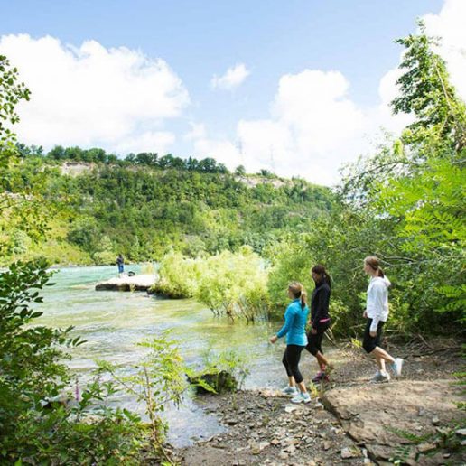 A family hiking by a river in Buffalo, NY